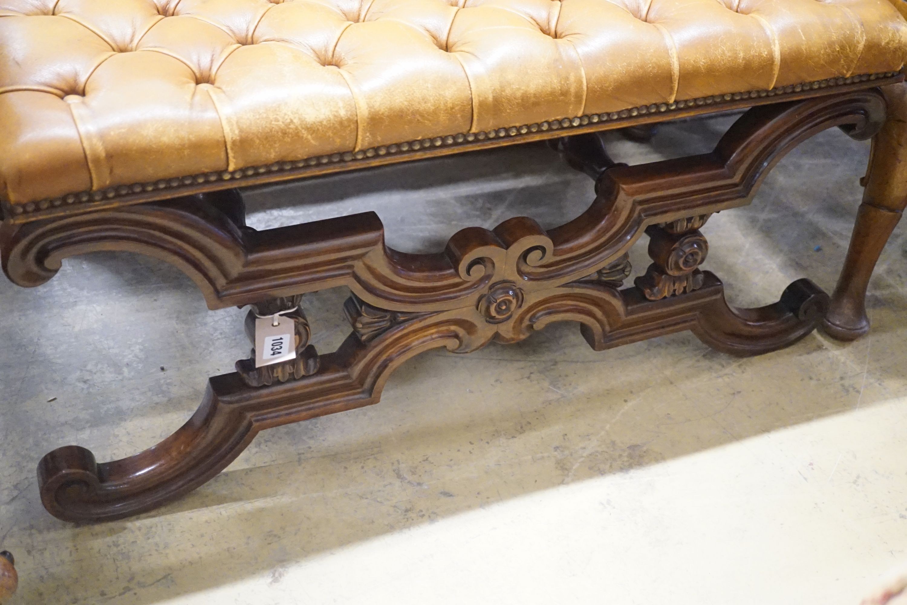 A Victorian carved X-framed rosewood footstool, upholstered in a buttoned brown leather, width 90cm depth 57cm height 42cm